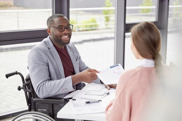 african-american-male-sits-at-workplace-in-wheelchair.jpg