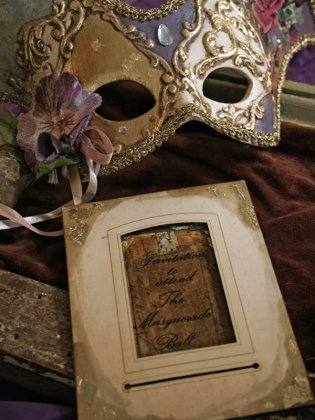 masquerade ball invitation with mask and paper invitation