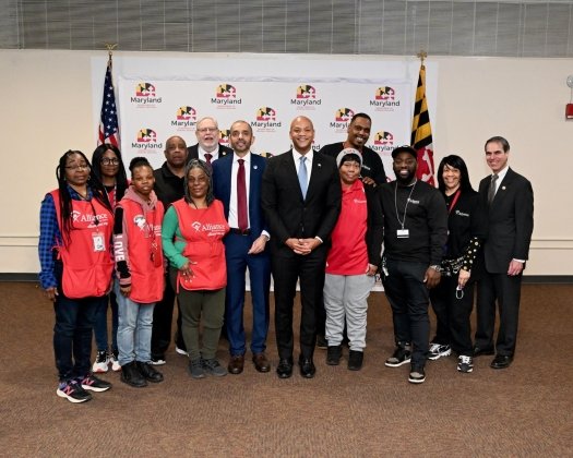 Governor Moore and a group of workers and others at the Department of General Services pose for a picture